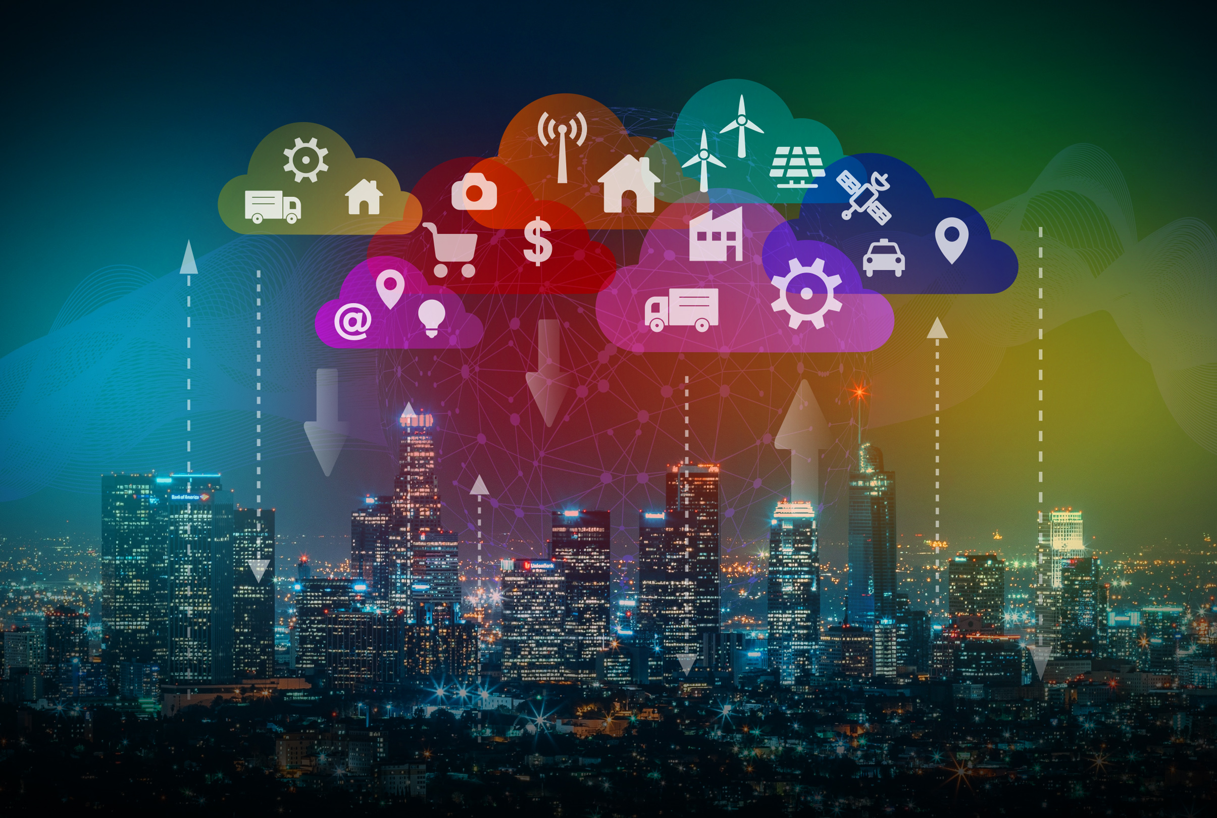 A city skyline at night beneath illustrated clouds packed with icons for vehicles, buildings, sensors and wind turbines