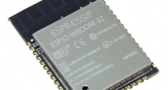 Close-up of an Espressif ESP32-WROOM-32 module, showing its metal RF shield and castellated edge pins